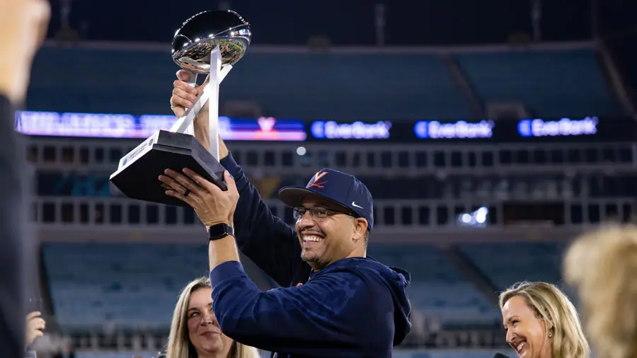 Tony Elliott hoisting trophy