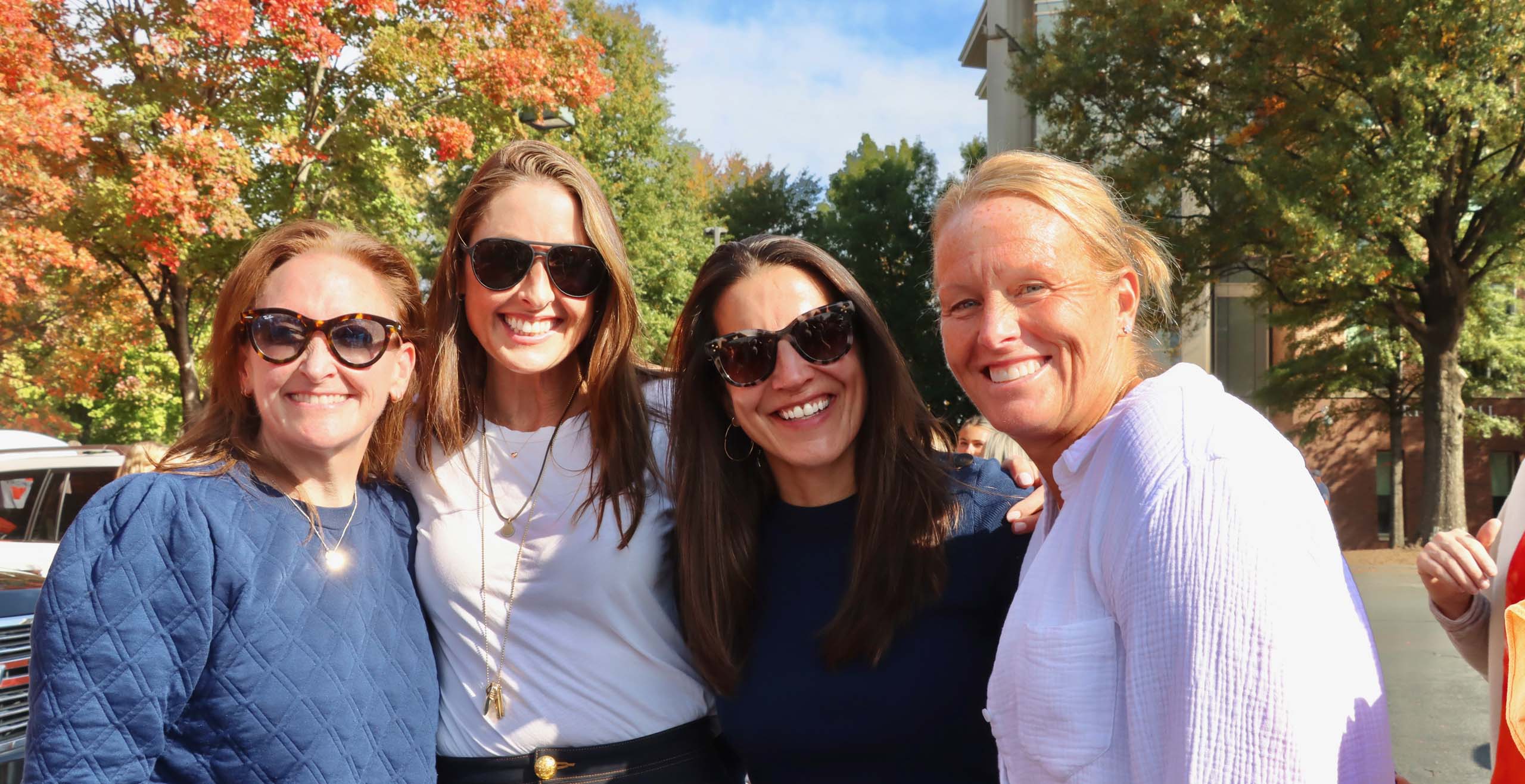 Four women posing together for photo