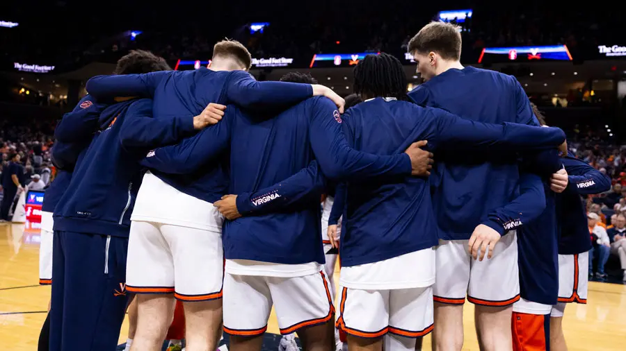 A womens basketball huddle on the court