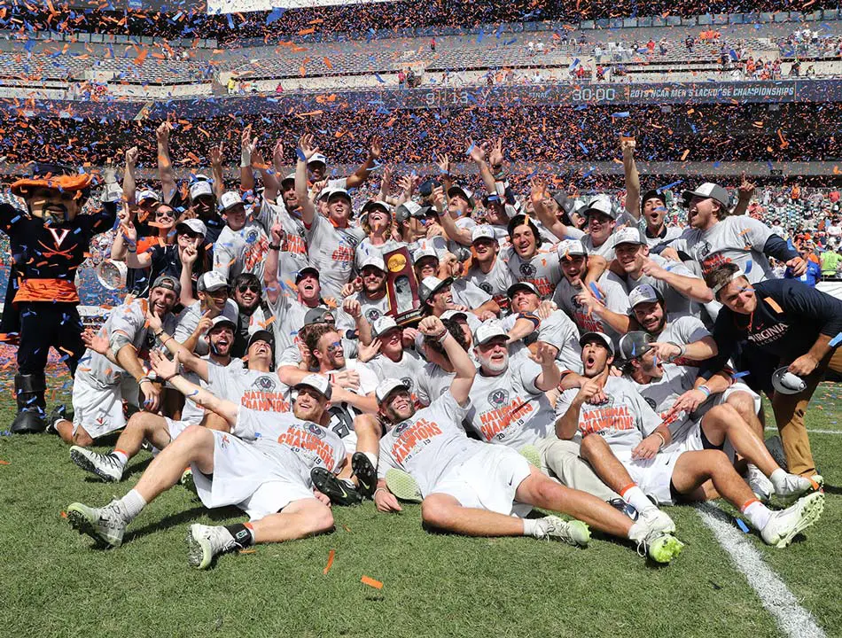 lACROSSE TEAM CELEBRATING national championship on field