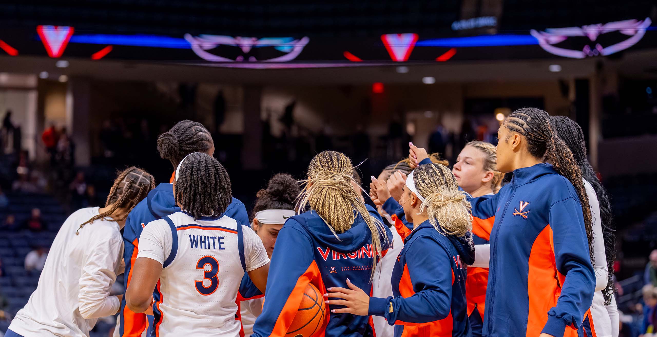Women's basketball team posing on the court